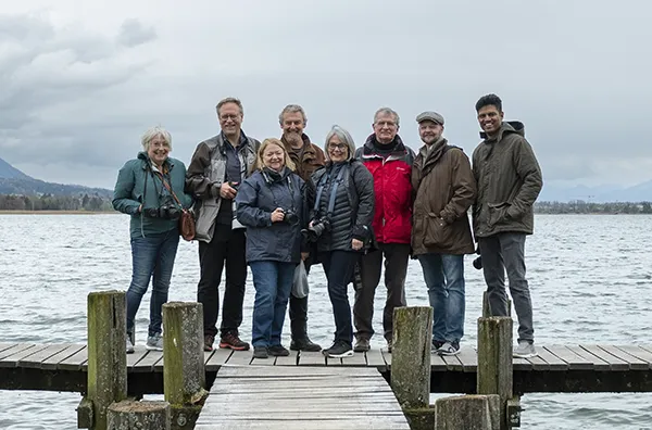 Group of photographers on a wooden dock at a lake in Switzerland